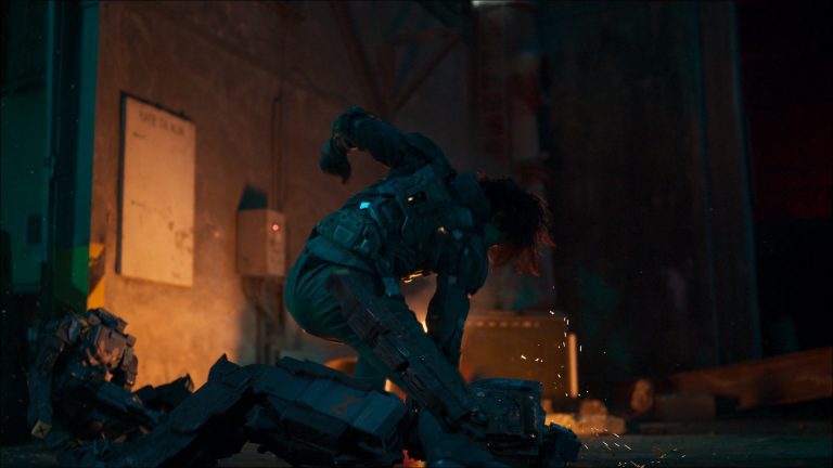 Magic Media and JUNG_E VFX, a person in a heavy, futuristic armor suit kneels among scattered debris, suggesting a moment of exhaustion or defeat in a dimly lit urban environment.