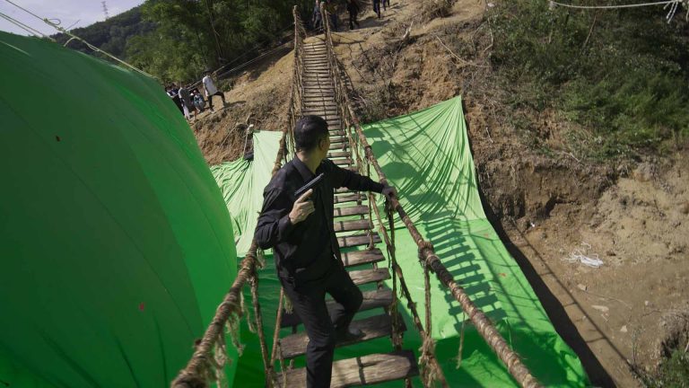 Magic Media VFX showcases an action setup with a man crossing a rope bridge against a green screen, hinting at the post-production process where visual effects will be added.